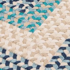 a blue and white rug with braiding on the bottom is shown in close up