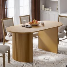 a table with some fruit on it in a living room next to a chair and window