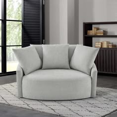 a gray chair sitting on top of a white rug