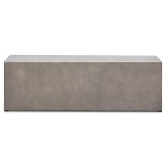 the concrete bench is made from cement and has a long, narrow shelf for storage