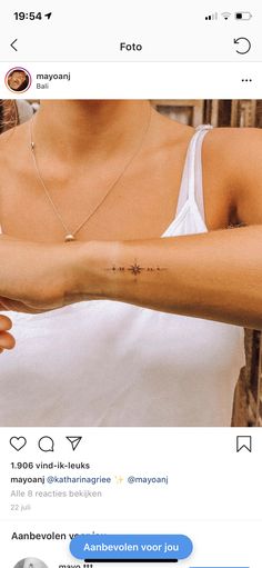 a woman with a small cross tattoo on her arm