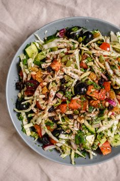 a bowl filled with lots of different types of food on top of a white table cloth