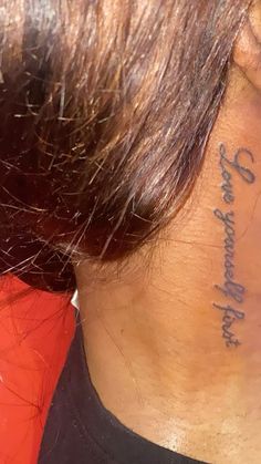 the back of a woman's neck with writing on it