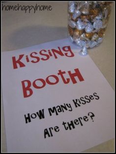 a sign that says kissing booth how many kisses are there? next to some candy