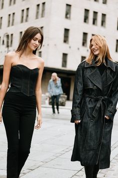 two women walking down the street together