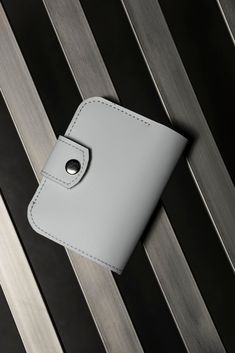 This wonderful white bifold wallet -- a perfect combination of elegance and practicality. Crafted from high-quality leather, it features a slim design and plenty of pockets for convenient storage of cash, credit cards, and coins. With customization options available, this wallet makes a unique gift, ideal for both yourself and your loved ones. It's more than just an accessory -- it's an expression of your style and individuality that will elevate your look in any situation. Material: genuine lea Modern White Wallet With Rfid Blocking, Modern White Wallet As Gift, White Rfid Blocking Wallets For Everyday, Classic White Card Holder For Everyday, White Bifold Wallet As Gift, Classic White Card Holder For Everyday Use, Modern Bifold Card Holder As Gift, White Wallets With Interior Card Slots For Everyday, Elegant White Wallet As A Gift