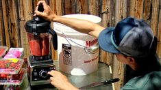 a man is using a blender on a table