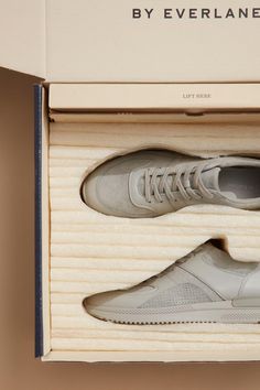 a pair of white sneakers in a box