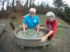 an older man and woman playing with a wheel barrow