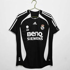 a soccer jersey hanging on a hanger in front of a white wall with the words beno semens printed on it