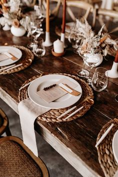 the table is set with plates and place settings