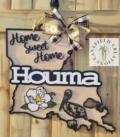 a wooden sign that says home sweet home, houma with the state of rhode on it