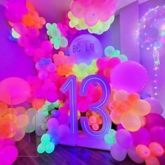 the balloon arch is decorated with balloons and streamers for an eighteenth birthday party