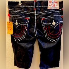 These Are A Size 33 Dark Navy Blue True Religion Jean Shorts With A Cut-Off Look That Are Trimmed In Red And White. Denim Shorts With Contrast Stitching, Fitted Bottoms With Contrast Stitching For Summer, Fitted Summer Bottoms With Contrast Stitching, Blue Bottoms With Contrast Stitching For Summer, Dark Navy Blue Color, True Religion Shorts, Light Denim Jeans, Mens Jean Shorts, Black Jean Shorts