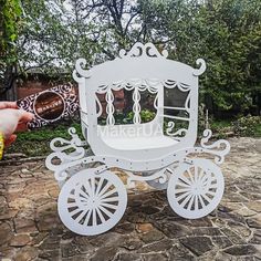 a white horse drawn carriage sitting on top of a stone ground