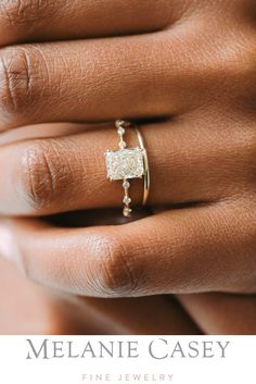 a woman's hand with a ring on it and the words melanie casey fine jewelry