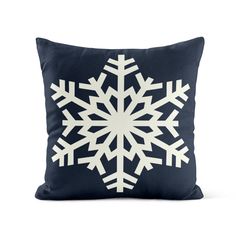 a blue pillow with white snowflakes on it