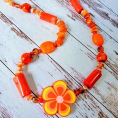 This Artist Custom Design Screams Sunny Day! Crafted With Sea Coral, Orange Bamboo Coral, Ceramics, Crystal, Custom Czech Glass And A Polymer Clay Flower Accent, This Necklace Has Color And Texture Galore. Remake An Old Outfit Feel New Again With This Unique Accessory. 18 Inch Length With A 2 Inch Extension Chain For Perfect Fit. *Longer Lengths Can Be Requested. Orange Clay Jewelry For Gifts, Handmade Orange Red Coral Necklace, Bohemian Orange Necklace, Summer Orange Flower-shaped Jewelry, Polymer Clay Beaded Necklace, Bone Bead Necklace, Orange Bohemian Flower-shaped Jewelry, Green Gemstone Necklace, South Sea Pearl Necklace