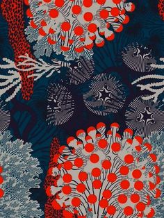 an orange and blue pattern with red flowers on it's side, in the middle of