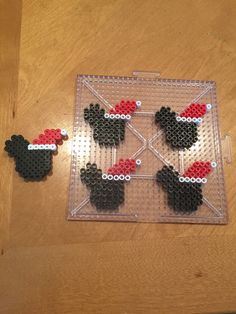 some black and red mickey mouses are on a clear plastic tray with holes in the middle