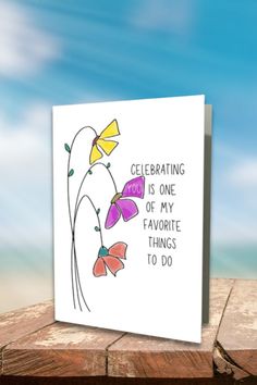 a card with flowers on it that says celebrating is one of my favorite things to do