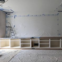 an unfinished room with white paint and shelves