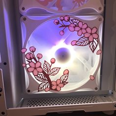 the inside of a computer case with pink flowers on it's glass front door