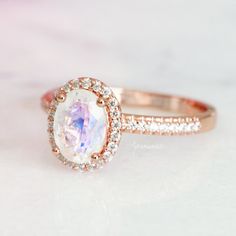 Gorgeous Oval Moonstone Ring ►Available in solid rose gold with a gold purity of your choice: 10K/ 14K/ 18k (can be made in yellow or white gold upon request) ►Accented with simulated diamonds, natural diamond, or moissanites of your choice (select option from the drop-down menu) Center stone: Moonstone Stone cut: Oval Gem size: 8.0 x 6.0 mm Carat weight: 1.21 ct. Gemstone creation: 100% Natural Treatment: None ►Side stones information: #Natural diamond side stone option: Gemstone: Diamond Gemst Rose Gold Moonstone Ring, Engagement Roses, Gold Moonstone Ring, Dainty Engagement Rings, June Birthstone Ring, Moonstone Engagement, Moonstone Engagement Ring, Rainbow Moonstone Ring, June Birthstone