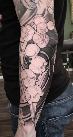 a person with a tattoo on their arm and flowers in the middle of his arm