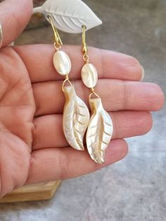 Mother of Pearl Earrings, Stainless Steel Earrings, MOP, Gold Earrings, Boho Earrings, Shell Earrings, Gemstone Earrings, Pearl Earrings, Plant, Leaf The earring hooks are stainless steel. These beauties are 3 inches long and have a beautiful sheen in the light. Mother of Pearl can be an part of anyone's path to releasing old emotions or deepening their spiritual connection. Wearing Mother of Pearl jewelry is said to attract prosperity, heighten intuition, and stimulate the imagination. Mother Of Pearl Single Earring For Gift, Mother Of Pearl Single Earring As A Gift, Single Mother Of Pearl Earring For Gift, Single Mother Of Pearl Earring As A Gift, Mother Of Pearl Single Drop Earring, Handmade Mother Of Pearl Teardrop Earrings, Mother Of Pearl Teardrop Jewelry Set, Mother Of Pearl Teardrop Jewelry With Matching Earrings, Mother Of Pearl Matching Drop Earrings Jewelry