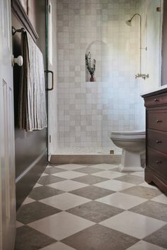 a white toilet sitting next to a walk in shower