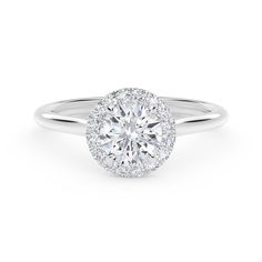 a white gold engagement ring with an oval halo setting and round brilliant cut diamonds on the band