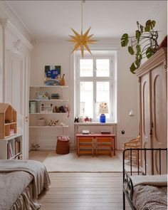 a bedroom with white walls and wooden floors