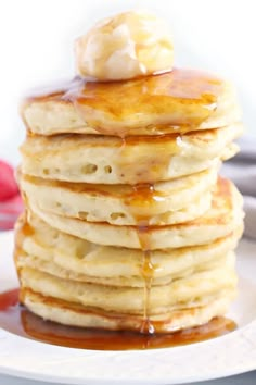 a stack of pancakes covered in syrup and butter