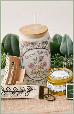 a jar with a wooden lid sitting on top of a table next to other items