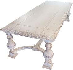 an old white wooden table with ornate carvings on the top and base, isolated against a white background