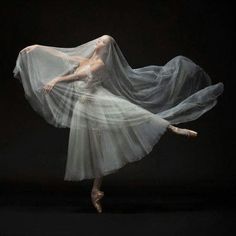 a ballerina in white tutu and veil dancing