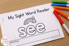 a sight word reader with three markers on top of it and two pens next to it