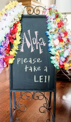 a sign that says nola please take a lei with colorful leis around it