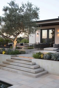 an outdoor living area with steps leading up to the patio