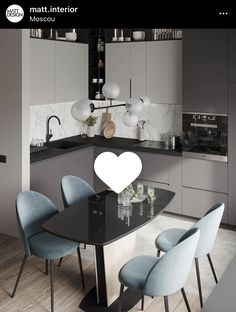 a black table with blue chairs and a white heart on the top in a modern kitchen