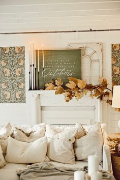 a living room filled with lots of furniture and decor on top of a white couch