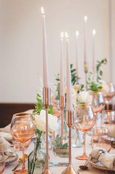 the table is set with candles and wine glasses