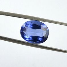 a blue oval shaped gems sitting on top of a wire