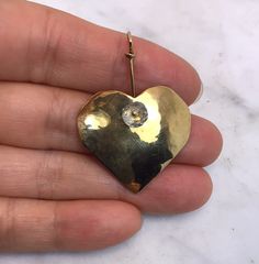 It’s in good condition. It measures 1 5/8” long 1 1/8” wide Marked aw/ 1/02 18K Weights 5.55 grams Thanks for looking! Handmade 14k Gold Heart Jewelry, Gold Heart Cut Collectible Jewelry, Collectible Gold Jewelry With Heart Charm, Collectible Heart Cut Gold Jewelry, Artisan Gold Heart-shaped Jewelry, Unique Gold Heart-shaped Earrings, Aquamarine Beads, Fine Jewellery Necklace, Heart Pendant