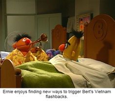 the muppets are in bed together and one is holding a toy with another hand