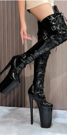 Discover the ultimate statement piece for your wardrobe with these Black Patent Leather Platform Ivory Thigh-High Boots. Perfect for clubbing, parties, or making any outfit stand out. These stylish boots are crafted from high-quality patent leather with a secure lace-up design and multiple buckles. Shop now and enjoy free returns and size exchanges. Elevate your style and confidence with every step! Black High-cut Knee-high Boots For Party, Round Toe Knee-high Boots For Club, Edgy High Cut Heeled Boots, Trendy High Cut Boots For Night Out, Edgy Thigh High Platform Boots For Party, Black High Cut Heeled Boots For Party, High-cut Winter Party Boots, Black High Cut Party Boots, High Cut Black Party Boots