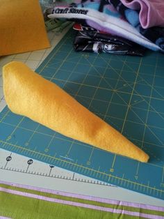 a piece of bread sitting on top of a cutting board next to a measuring ruler