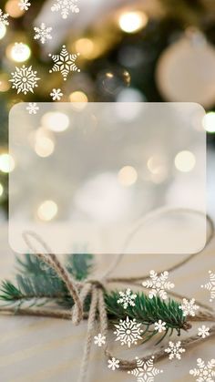 a christmas tree with snowflakes on it and a gift tag tied to the side