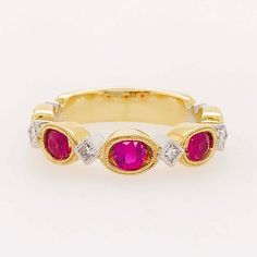 This "Ruby Romance" ring is gorgeous!! The rubies are round, faceted gemstones that are set in oval, milgrain bezels. The oval settings give the rubies an elongated look that's innovative and alluring! Set in between each ruby is a square-cut or princess cut, white diamond! The diamonds are natural diamonds that are bright white and very clean! The diamonds are set, on point, in white gold, square bezels with matching milgrain beading framing each stone. We currently have this ring with rose gol Oval Ruby Ring With Rose Cut Diamonds, Oval Red Ruby Ring With Three Stones, Classic Oval Lab-created Ruby Diamond Ring, Luxury Oval Three-stone Ruby Ring, Oval Diamond Ring With Lab-created Ruby Accents, Oval Ruby Ring With Three Diamonds, Oval Three Stone Ruby Ring With Diamonds, Luxury Bezel Set Ruby Ring, Classic Ruby Ring With Bezel Setting